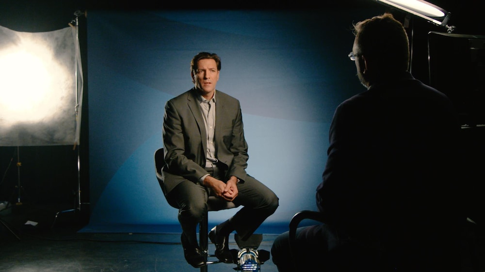 Patrice Brisebois est assis dans un studio de Radio-Canada en face du journaliste Jean-François Poirier.