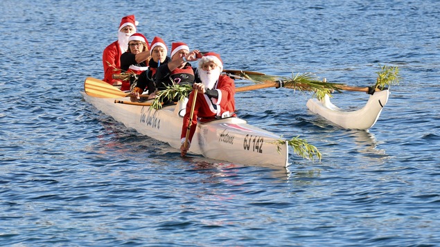 Des personnes déguisées en père Noël profitent de la traditionnelle baignade de Monaco pour pagayer en canoë. Des personnes déguisées en père Noël profitent de la traditionnelle baignade de Monaco pour pagayer en canoë.