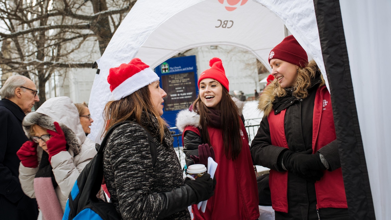 Staff from CBC Montreal's Communications department greet the public as they arrive for the 2017 CBC Christmas Sing-In in Montreal.
