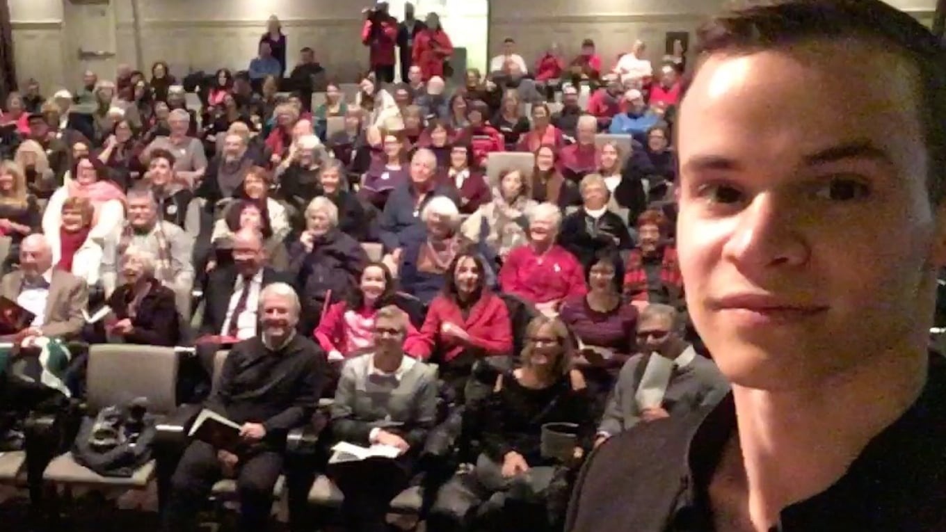 Conductor Francis Choinière takes a selfie with the audience at Bourgie Hall during the 2017 CBC Christmas Sing-In.