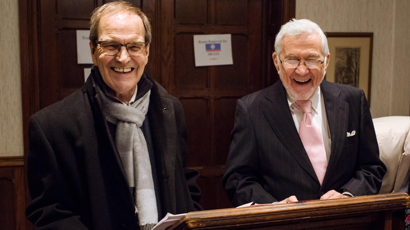 Michel Poitras (left) and Robert Koffend greet staff and musicians at the artists' entrance of the Church of St. Andrew and St. Paul.