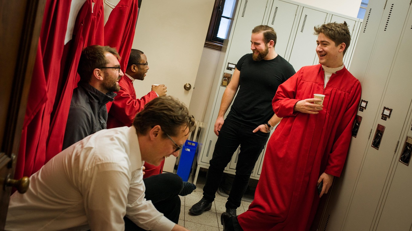 Choristers hydrate and share a laugh while robing up for the 2017 CBC Christmas Sing-In in Montreal.