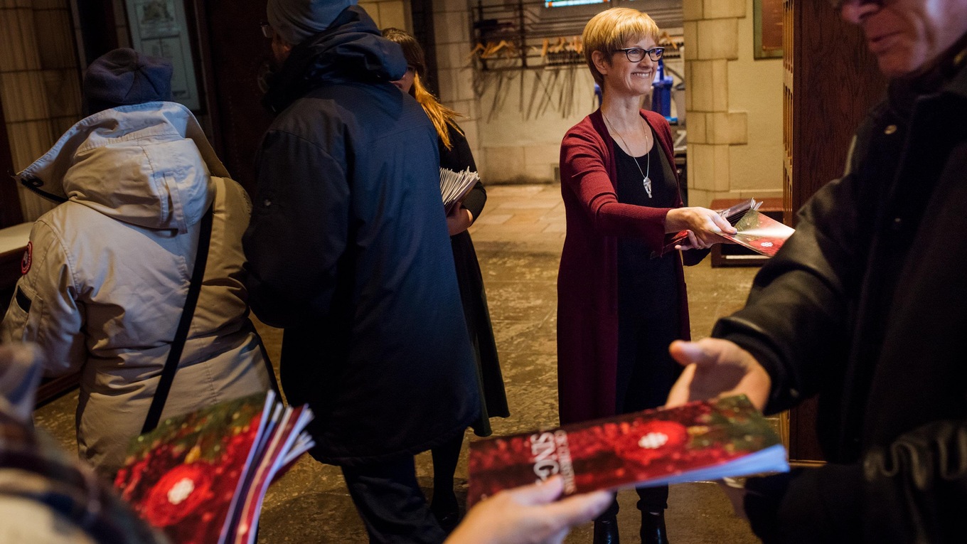 CBC Montreal's Nancy Wood greets the public arriving at the Church of St. Andrew and St. Paul for the 38th annual CBC Christmas Sing-In in Montreal.