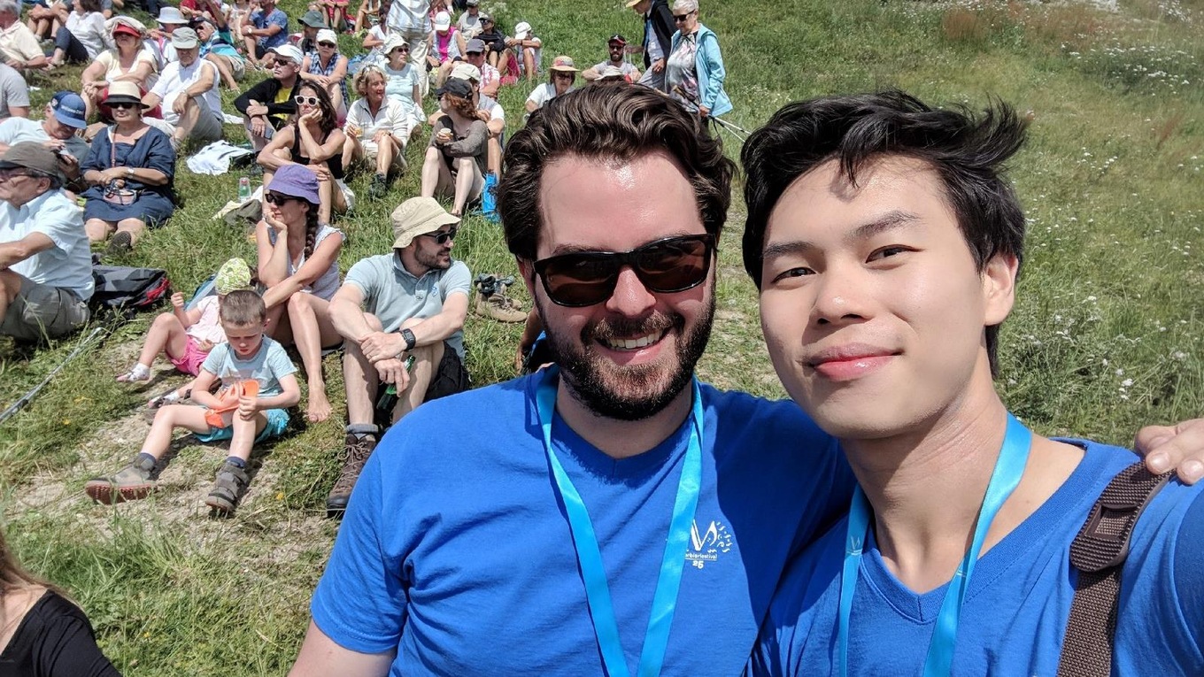 Conductor Simon Rivard (left) and violinist Timothy Chooi enjoy a moment following their outdoor concert at the 2018 Verbier Festival.