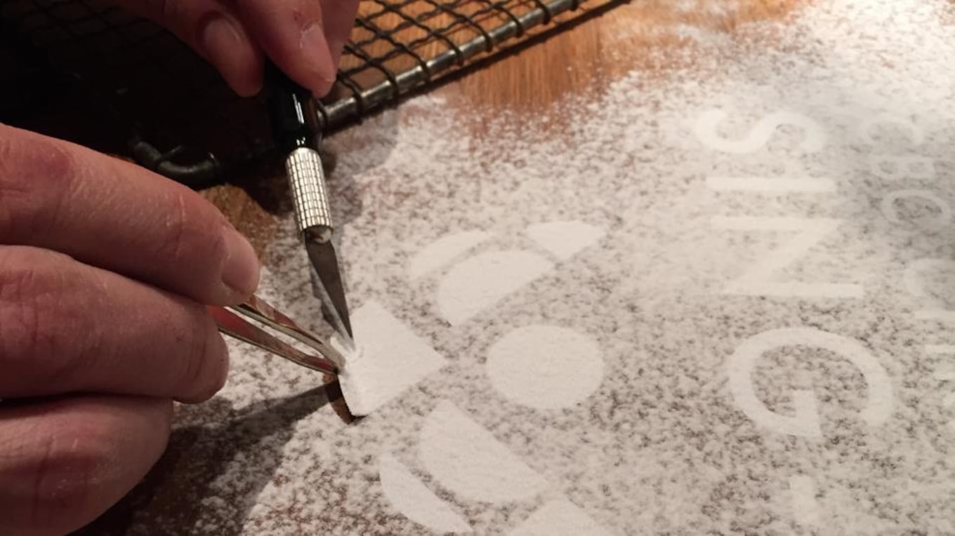 The area was then dusted with flour, and each piece of the stencil was painstakingly removed.