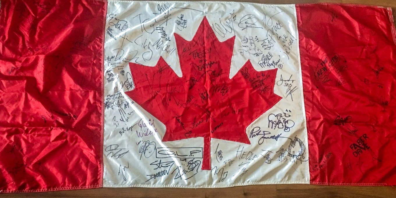 A flag featuring the signatures of 50 Canadian artists is being auctioned off in honour of Tragically Hip frontman Gord Downie.