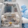 Des employés de Lockheed Martin retirent le couvercle de la boîte de retour de l'échantillon au centre spatial Johnson de Houston.