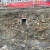 Une ouverture de pierres dans le sol dans une excavation.