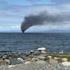 Un panache de fumée s'échappe d'un bateau de plaisance de 40 pieds en feu dans le détroit de Georgia, près de Qualicum Beach, sur l'île de Vancouver, le lundi 23 mai 2022.