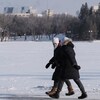 Des passants se promènent dans le parc Wascana de Regina, en Saskatchewan, le 18 février 2021 lors d'une vague de froid.