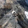 Un refuge en pierre construit sur un col de montagne.