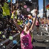 Une femme danse dans les bulles de savon au défilé de la fiertée gaie de Toronto en 2016.