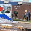Devant une école, des militaires en t-shirt et en pantalons de camouflage transportent de gros bacs de plastique et montent sur la rampe d'un camion U-Haul.