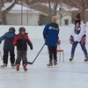 Des enfants apprennent à faire du patin avec des entraîneurs bénévoles.