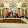 Des représentants de plusieurs pays sont assis autour de la table de négociations.