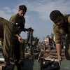 Israeli soldiers store ammunition at a staging area.