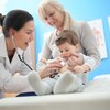 Une médecin écoute le cœur d'un bambin avec un stéthoscope dans une salle d'examen.