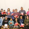 Photo de groupe, livre à la main, dans le gymnase de l'école. 