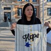 Odelia Quewezance devant la Cour avec un tissu sur lequel le mot "Hope" est inscrit, le 27 mars 2023.