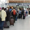 Des voyageurs attendant en file à l'aéroport Pearson de Toronto