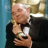 Stanley Donen serre sa statuette contre sa joue lors de la cérémonie des Oscars, le 23 mars 1998.