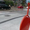 Un vélo rouge en métal avec un boulevard en arrière-plan.