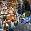 Une maisonnette et un train composent une partie du village miniature de Noël.                               