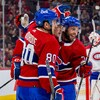 Des joueurs de hockey se font une accolade après avoir inscrit un but.