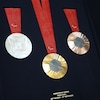 Des médailles d'or, d'argent et de bronze apparaissent sur un plateau de présentation.