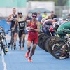 An athlete runs after leaving his bike in the transition area.