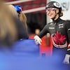 Elle s'appuie sur les matelas en bordure de la piste et sourit.