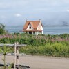 Une maison en été sur le bord de l'eau.