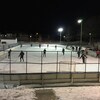 Des personnes joue au hockey sur une patinoire.