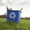 Un bac de recyclage déposé sur du gazon