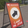 Affiche indiquant l'entrée des camps de jour dans un stationnement.