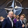 Le président des États-Unis, Joe Biden et le président de la France, Emmanuel Macron en dessous du logo de l'OTAN.