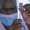 Travailleur de la santé qui remplit une seringue à partir d'une fiole.