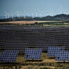 Des panneaux solaires photovoltaïques et des éoliennes en arrière-plan autour de la ville de Milagro, en Espagne.