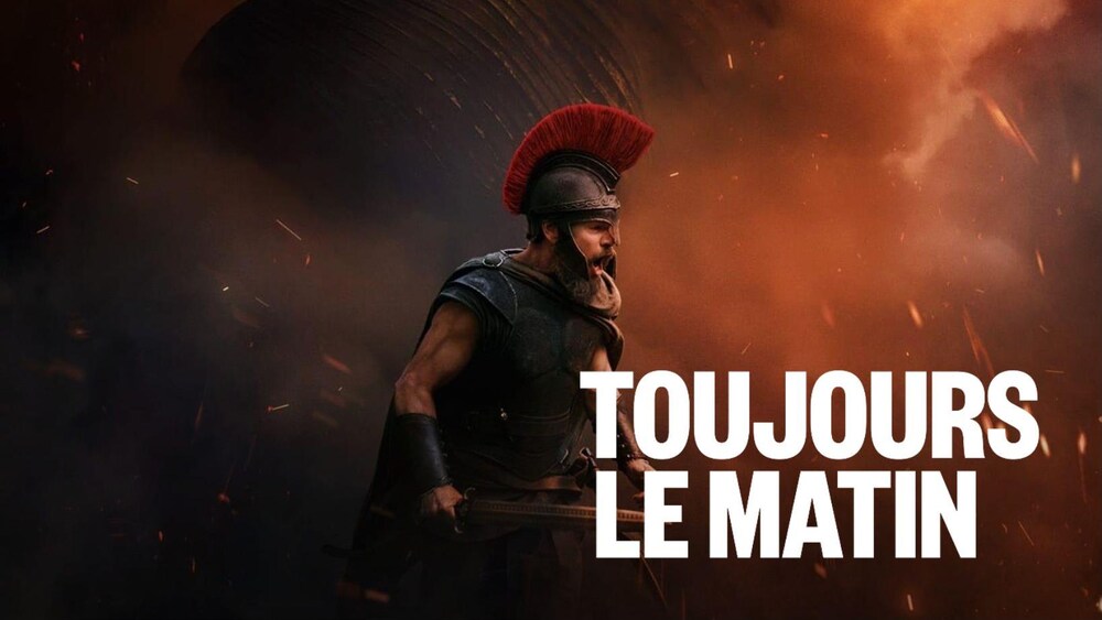 Un homme en armure crie devant un arrière-plan embrasé.