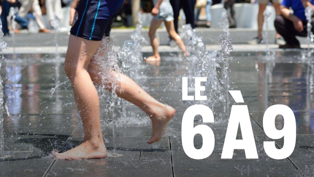 Un garçon en maillot de bain joue dans des jeux d'eau.