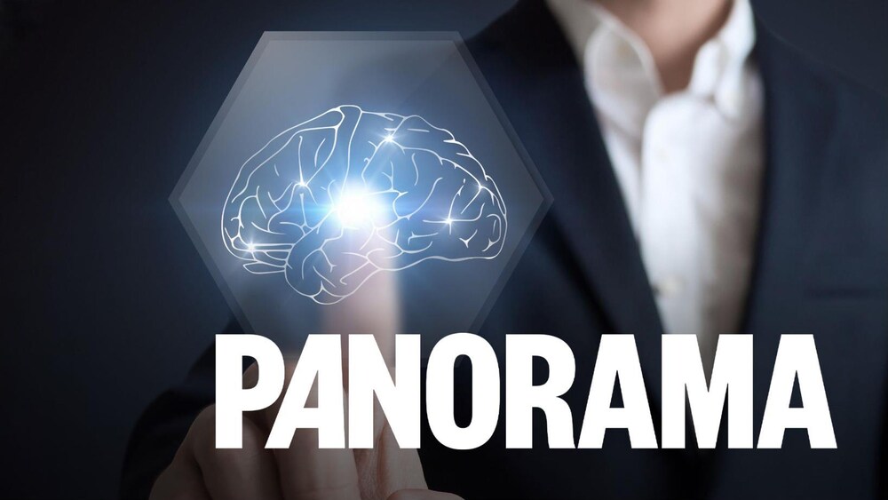 Un homme pointe une infographie de cerveau. 