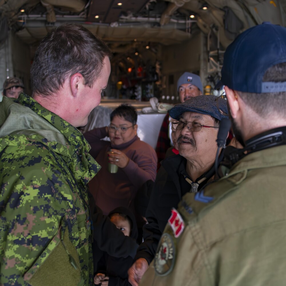 Un homme parle à deux soldats
