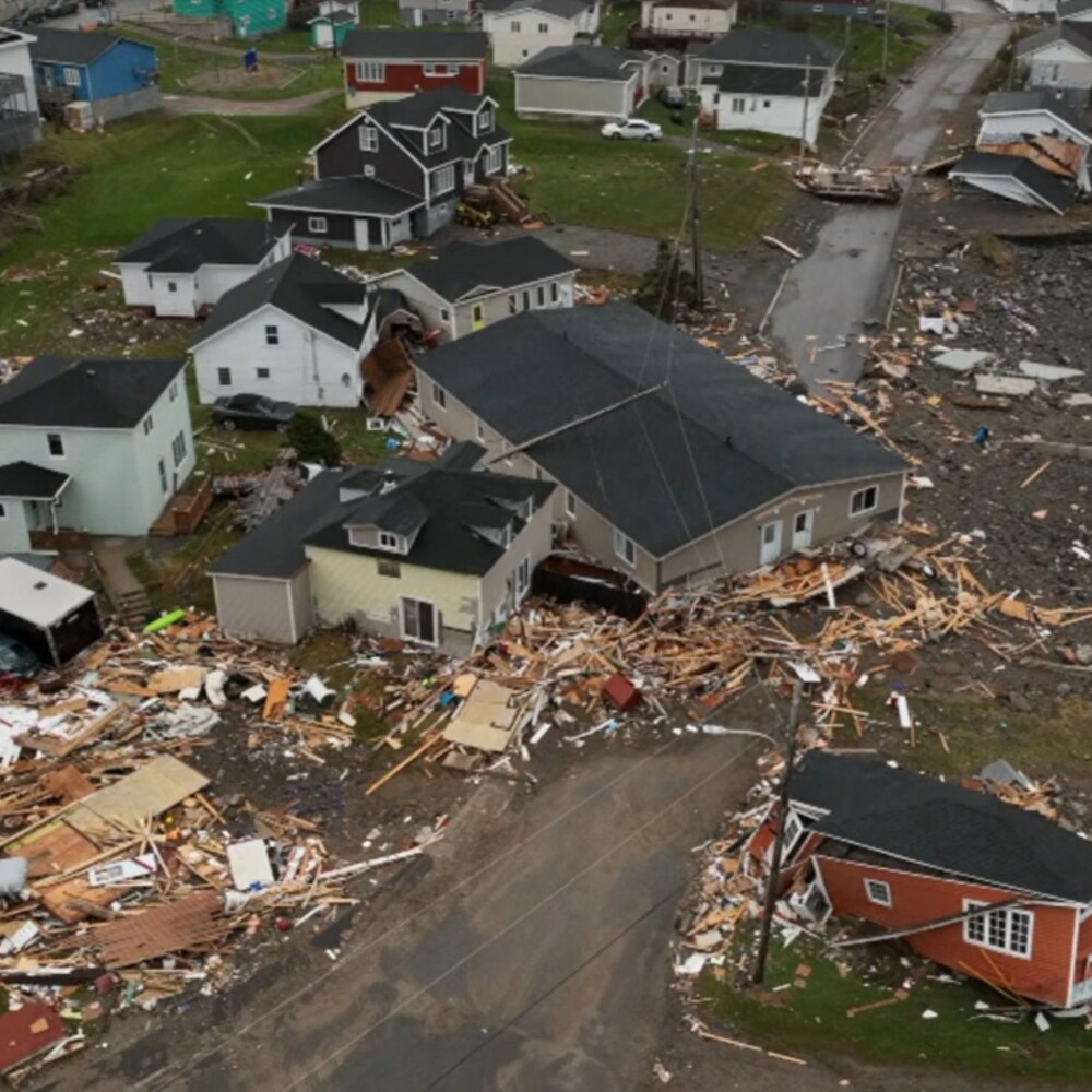 Des maisons détruites et un bâtiment déplacé par la tempête. 