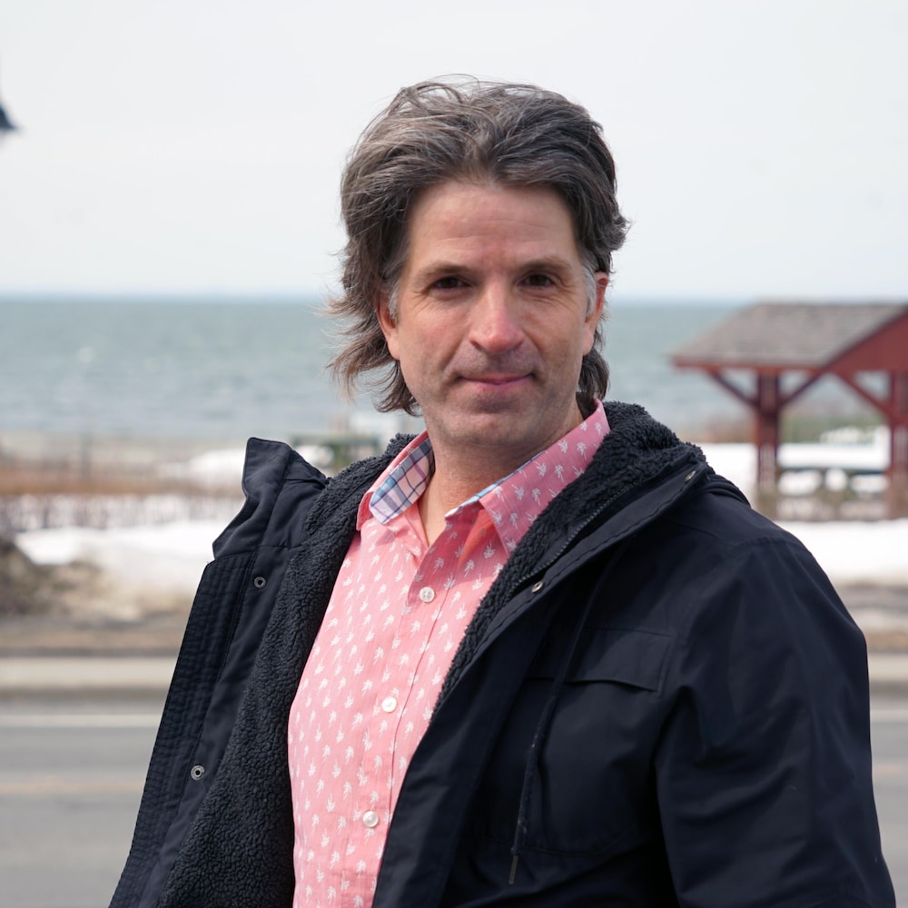 Jean-François Fortin devant une promenade au bord du fleuve, à Sainte-Flavie.