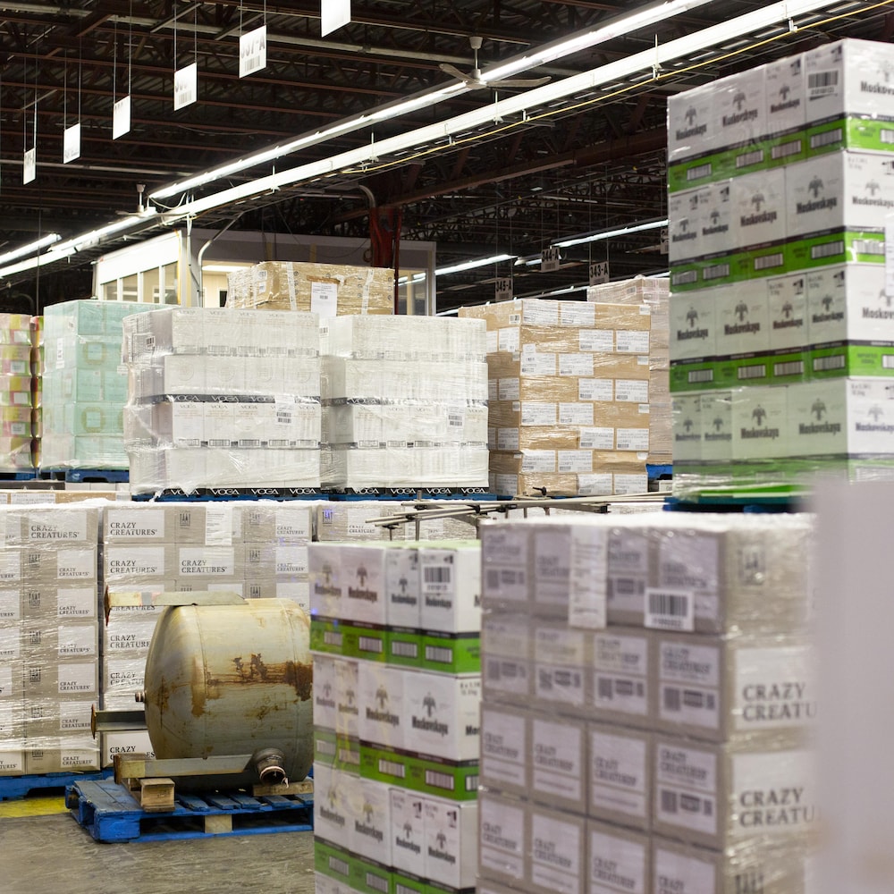 Des caisses d'alcool sont empilées dans l'entrepôt de la SAQ à Montréal.