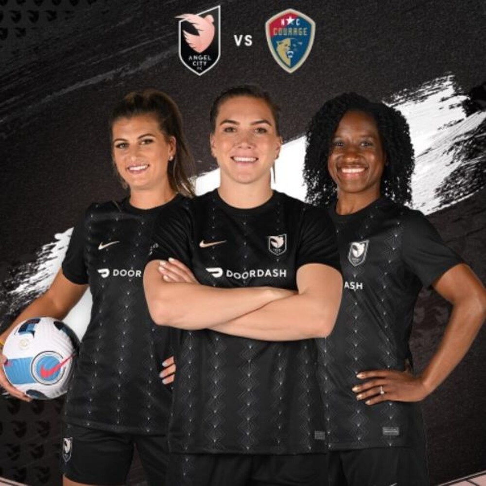 Three female soccer players pose for the camera.