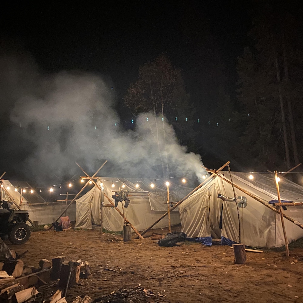 Des tentes éclairées la nuit.