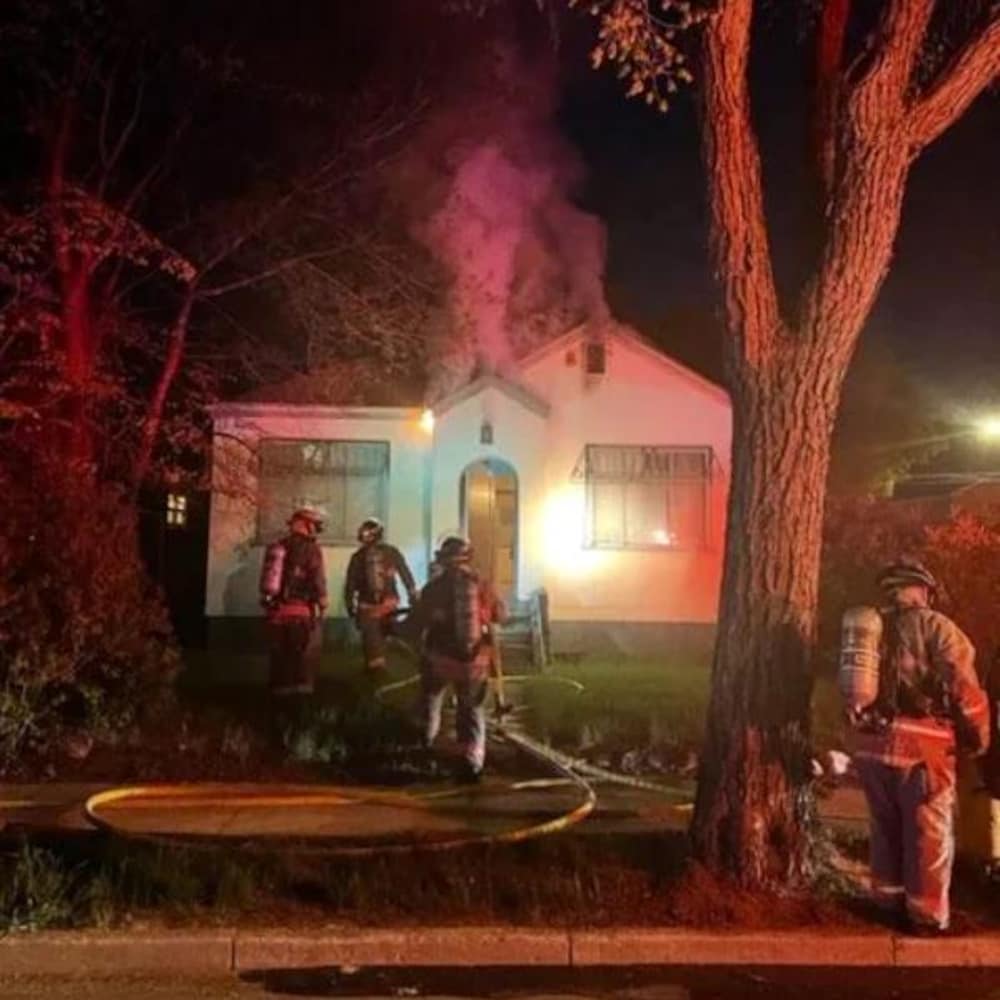 Smoke billowed from the roof of a house in Saskatoon while firefighters were in the area. 