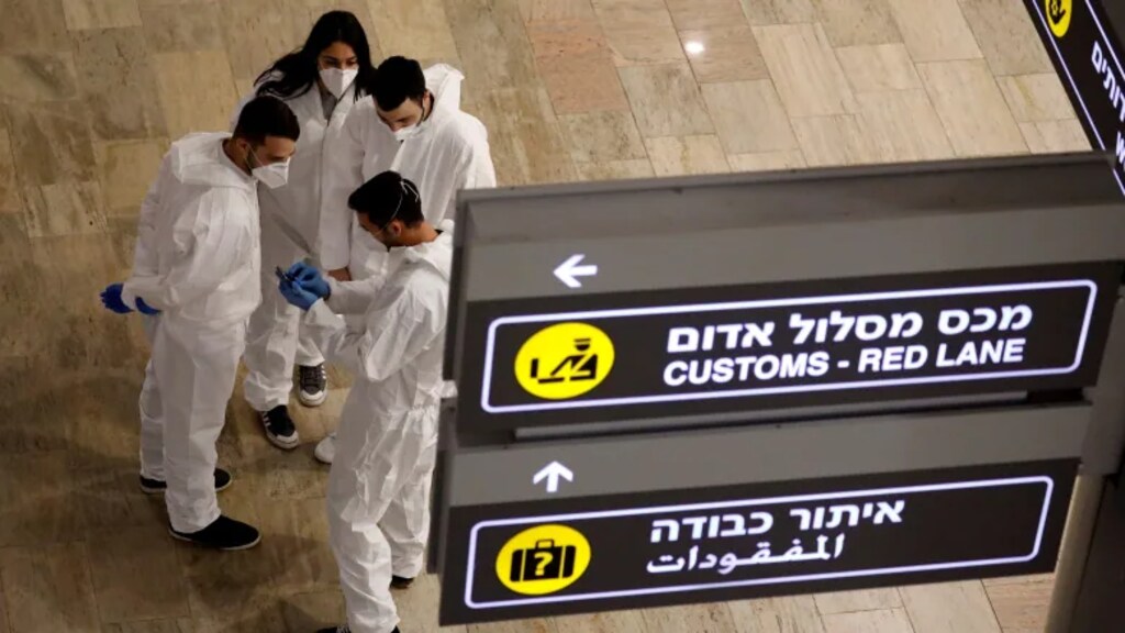 Workers that administer COVID-19 tests chat in the arrivals terminal of Ben Gurion international airport in Lod, near Tel Aviv, Israel, on March 1, 2021. A special meeting of the World Health Assembly is convening Monday to discuss pandemic preparedness.