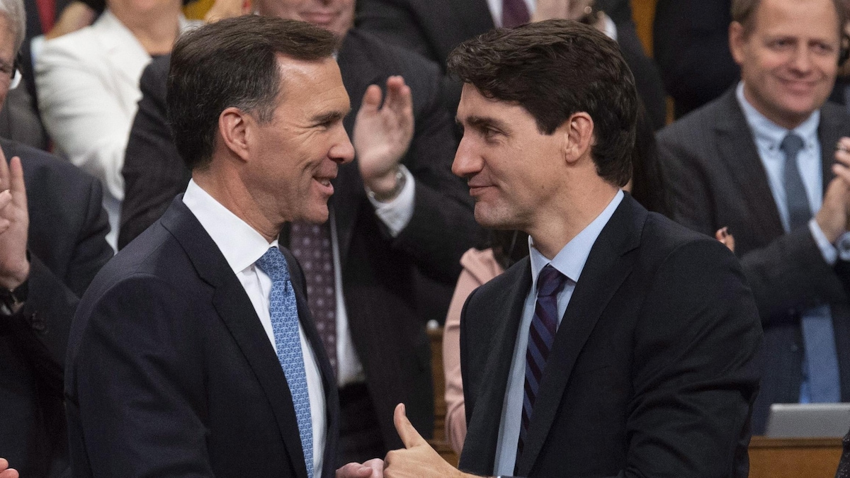 Bill Morneau et Justin Trudeau se font l'accolade. 